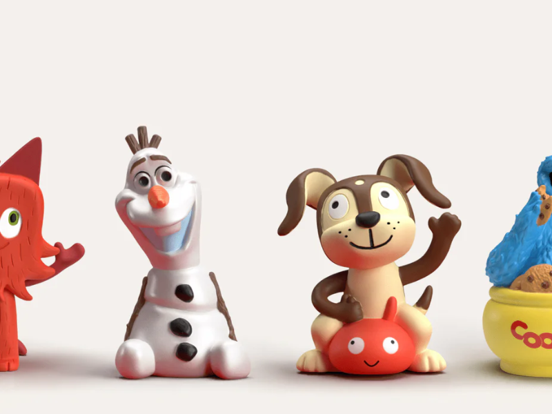 Colorful toy figures of a fox snowman dog and cookie jar