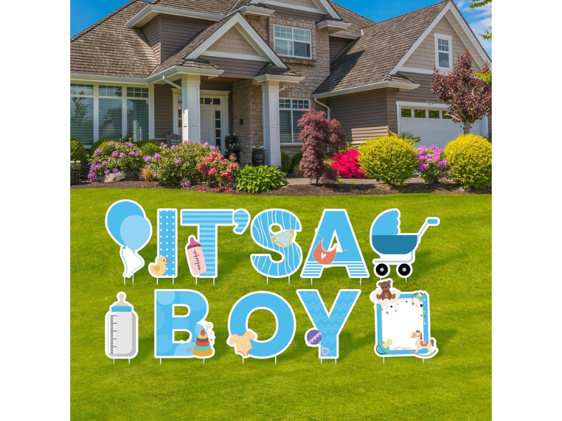 Lawn sign celebrating a new baby boy with colorful decorations