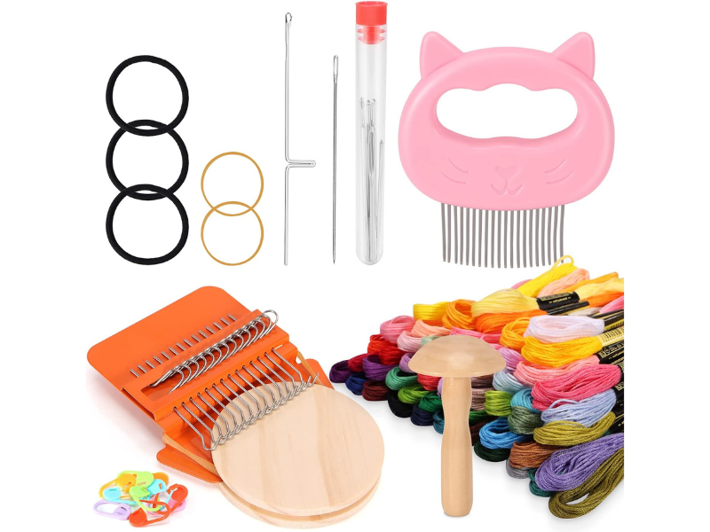 Craft supplies including threads tools and a cat-shaped comb